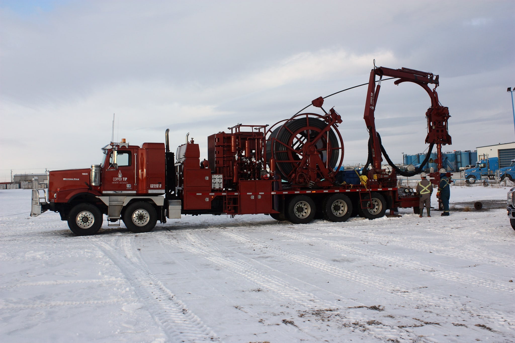 Copper Tip Energy Services crew in full PPE at a wellhead