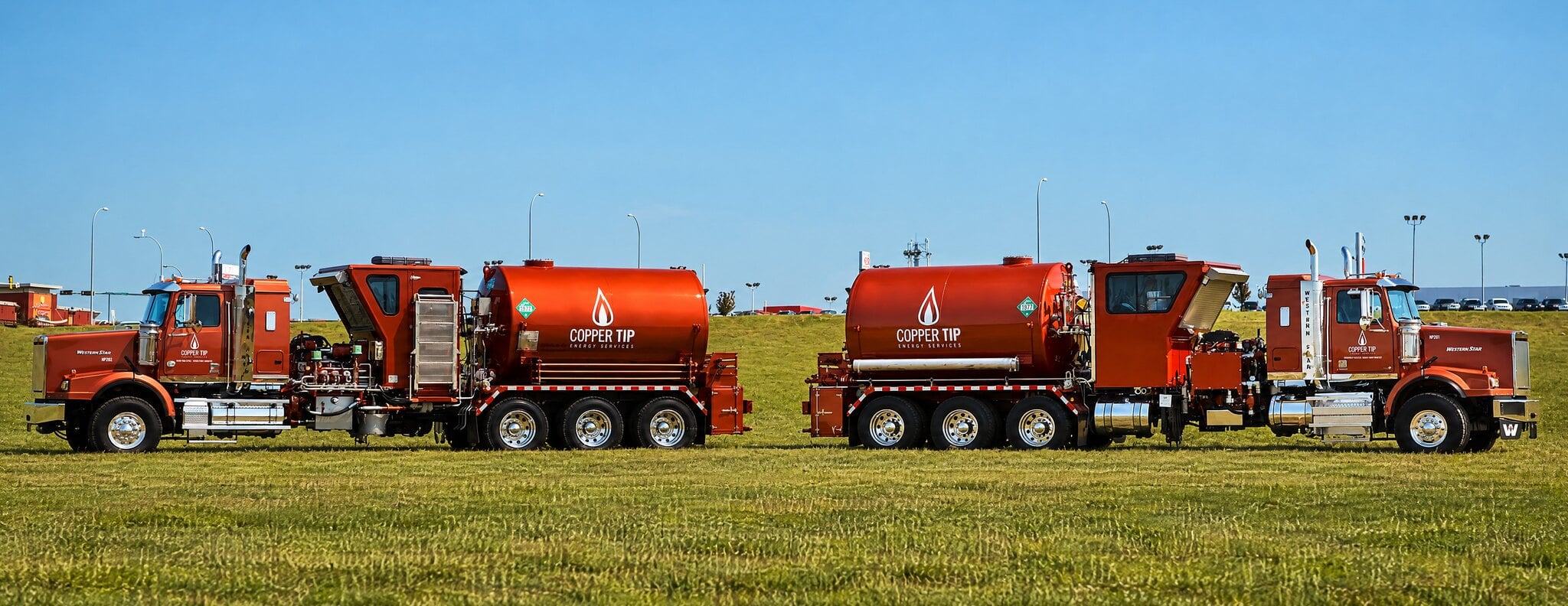 Copper Tip Energy Services pumping units parked back to back in a field