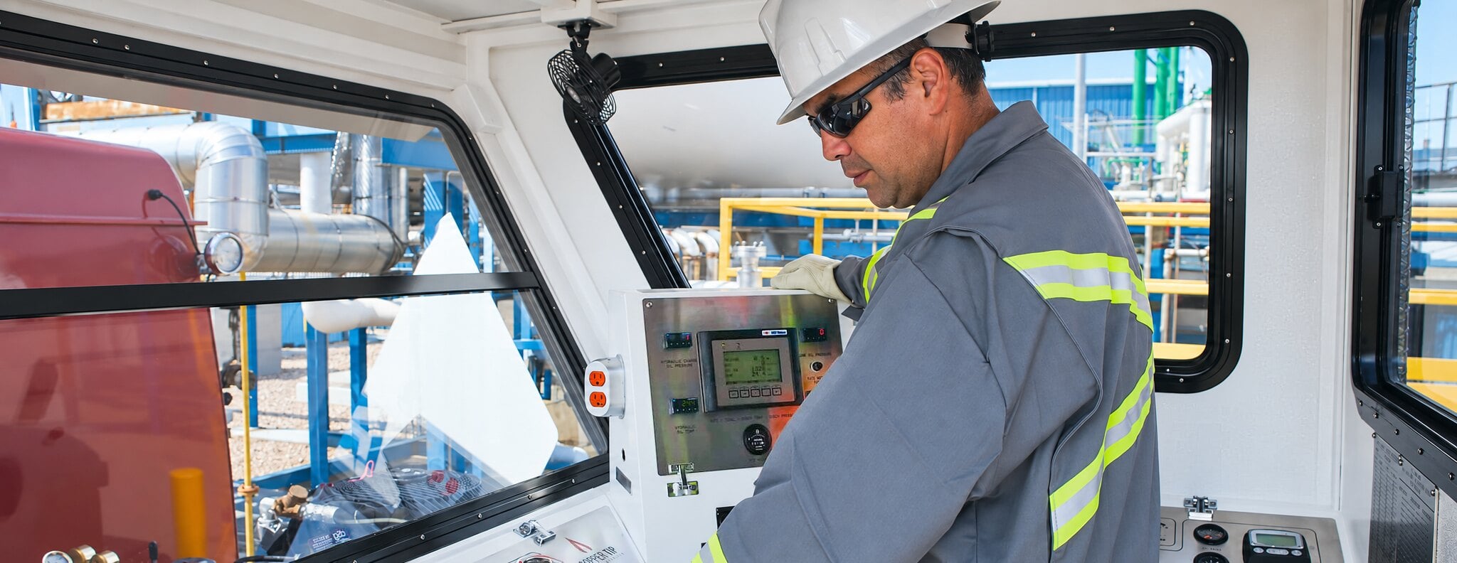 Copper Tip Energy Services operator at control panel in truck cab