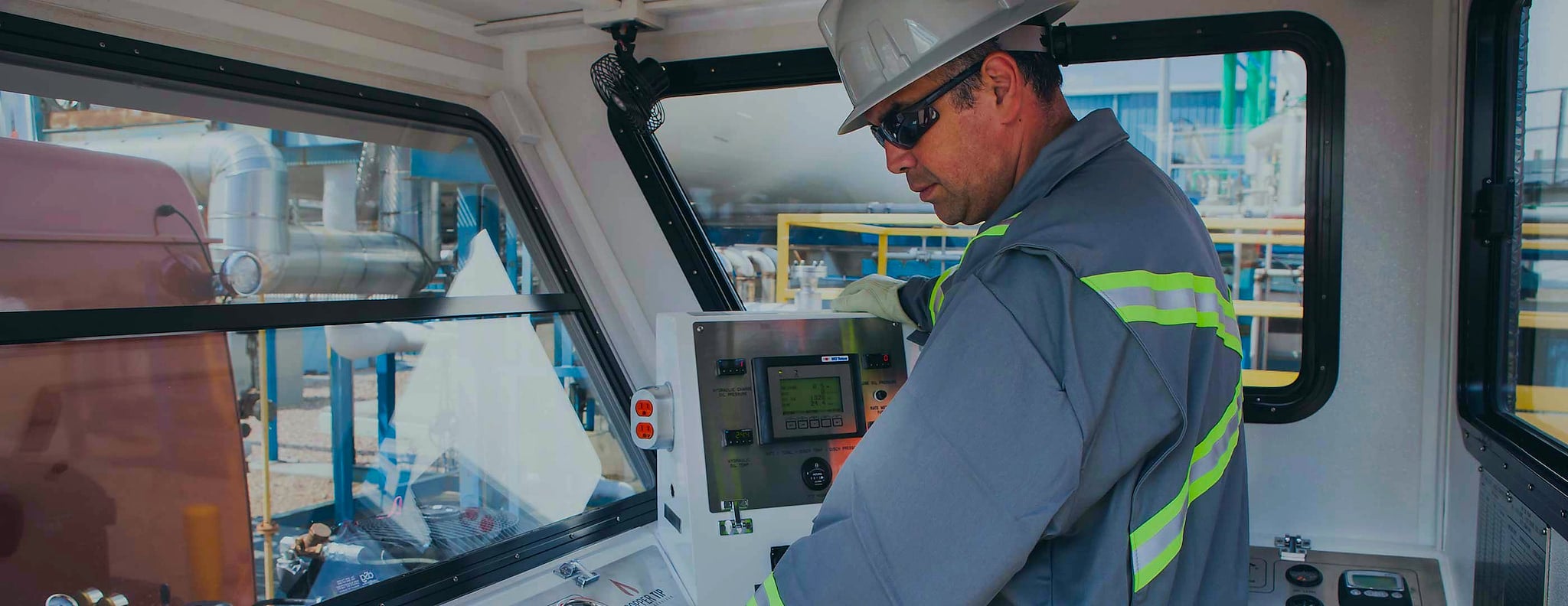 Copper Tip Energy Services operator at control panel in truck cab