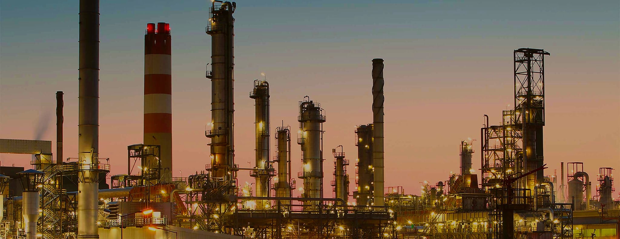 Refinery towers and stacks at dusk