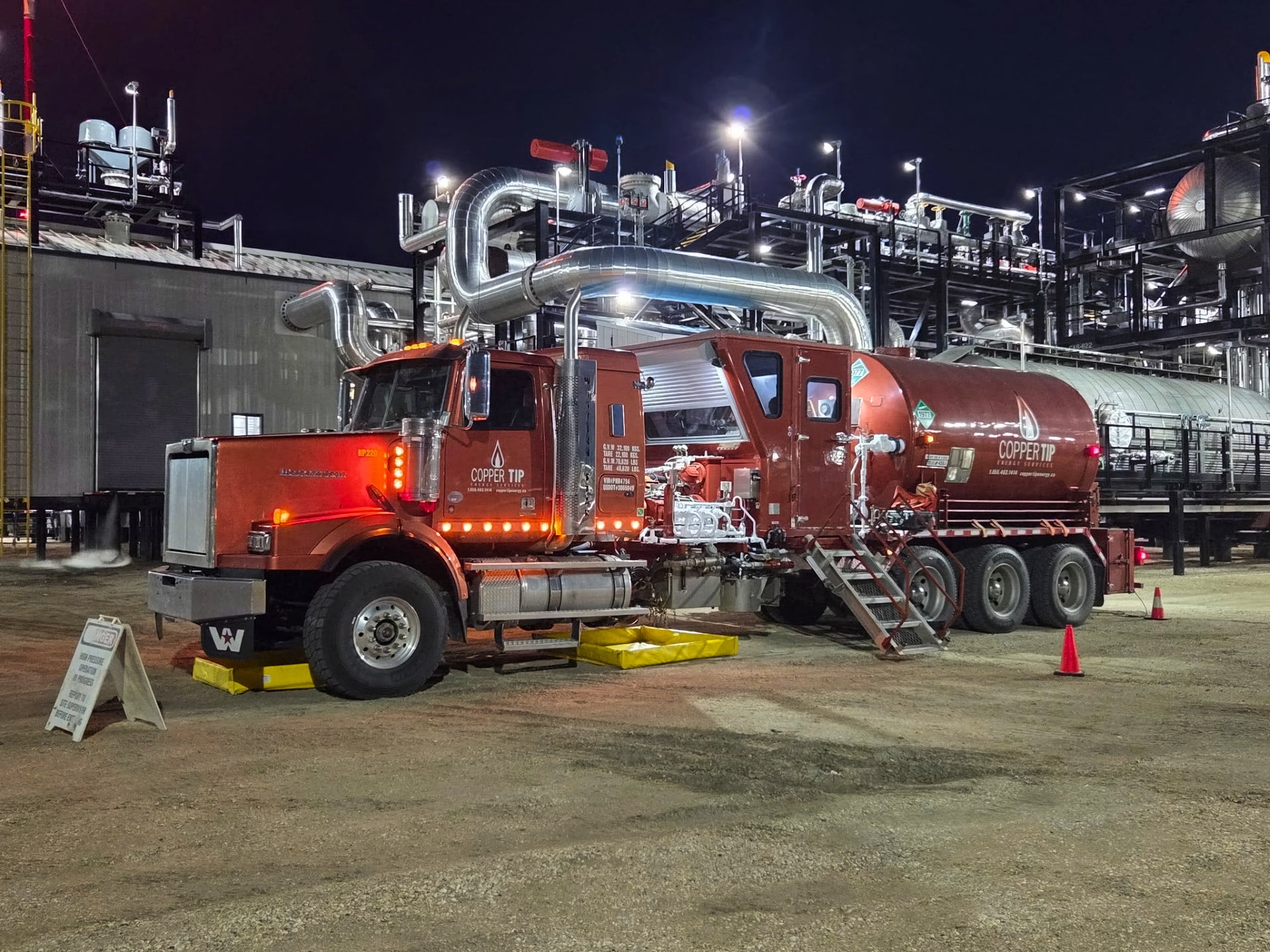 Copper Tip Energy Services nitrogen pumping unit rigged in at a gas plant at night