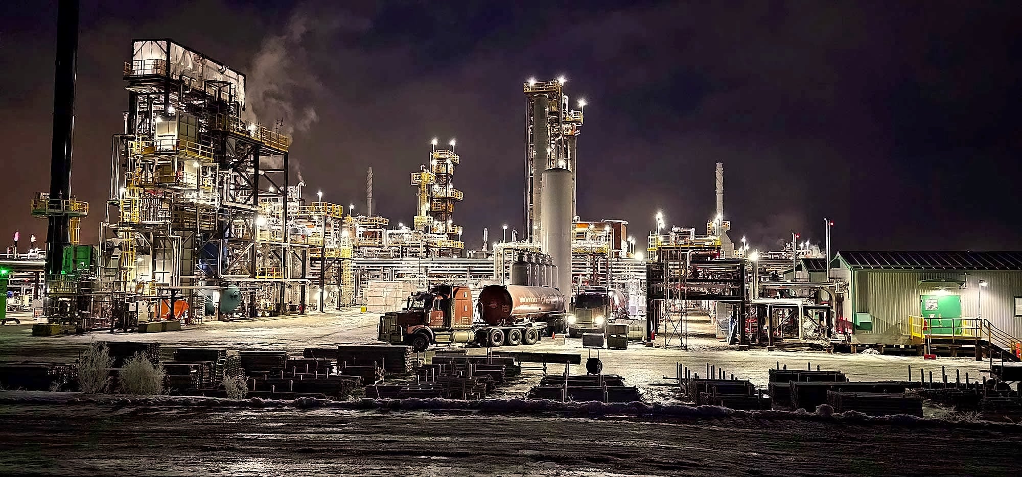 Copper Tip Energy Services truck at industrial plant at night with steam